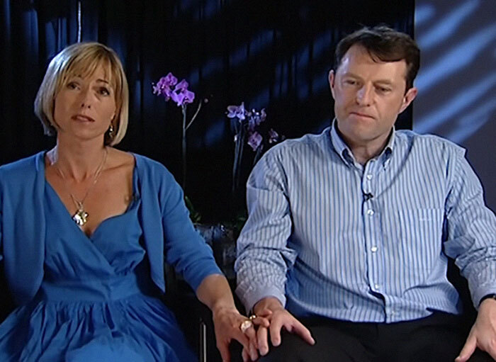 A couple holding hands, seated together during an interview on the Madeleine McCann case.
