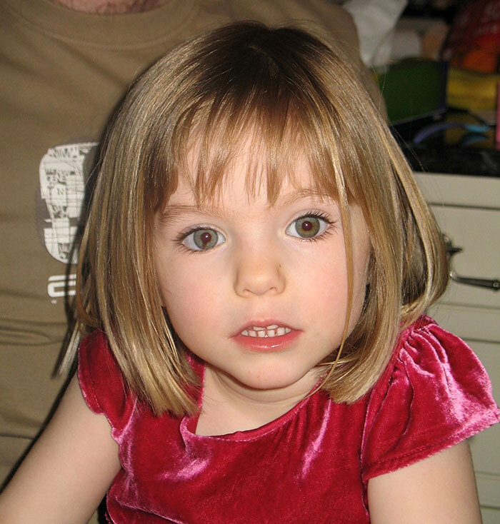 Young girl in a red dress, central to discussions about Madeleine McCann.