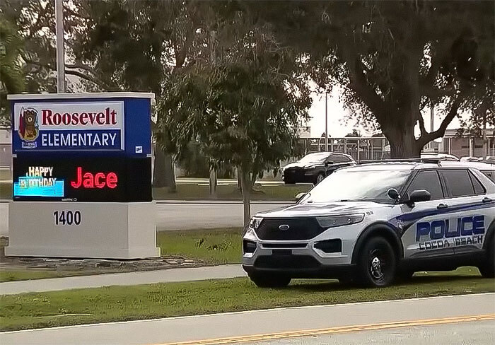Police car parked outside Roosevelt Elementary, related to school principal arrest incident.