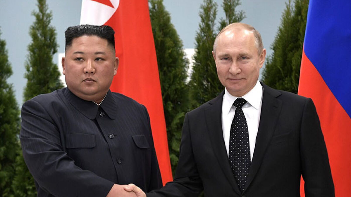 Putin and Kim shaking hands with flags behind them, referencing North Korean troop deployment in Ukraine conflict.