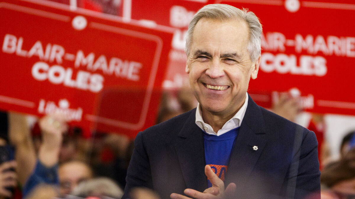 Mark Carney smiling and clapping during a Canada election victory speech addressing a hinge moment in politics.
