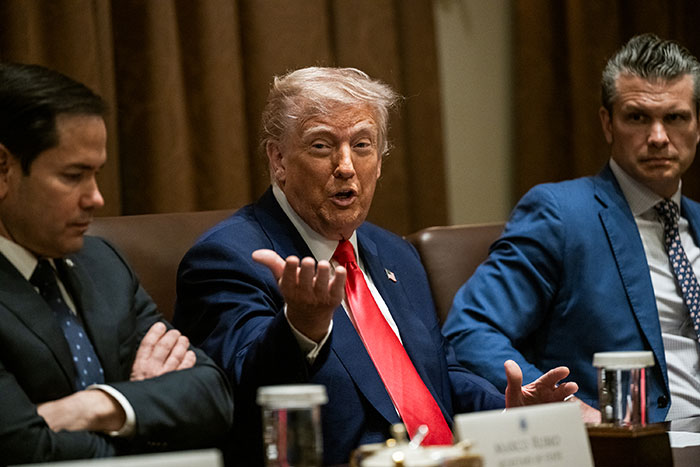 Trump Defense Secretary in a meeting, sitting at a conference table discussing topics.