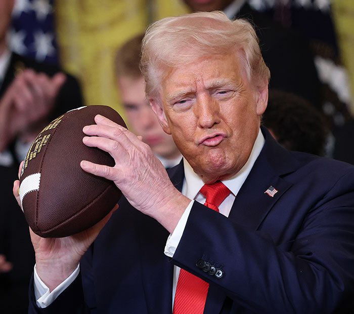 “Keep Them Down”: Trump Pulls Absurd Stunt To Look Taller Than Towering Ohio State Football Team