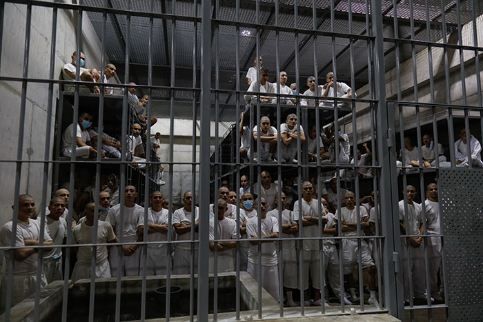 Inmates crowded in a prison cell; ICE agents involved in a mistaken kidnapping case.