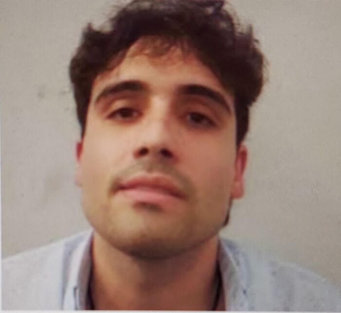 Young man with dark hair wearing a light shirt, related to Mexican cartel family members entering U.S. under Trump deal.