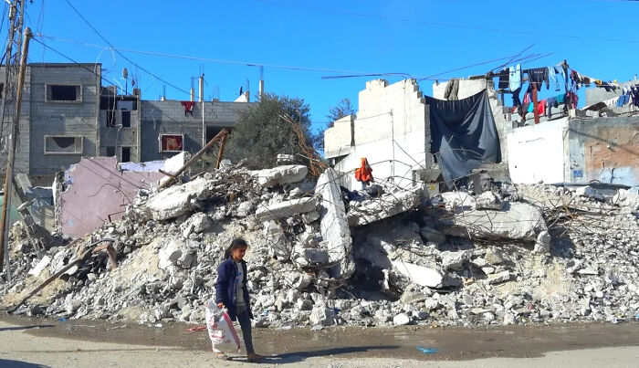 Child walks past rubble in Gaza as Pope Francis’ Popemobile is set to be converted into a mobile health unit for Gaza children