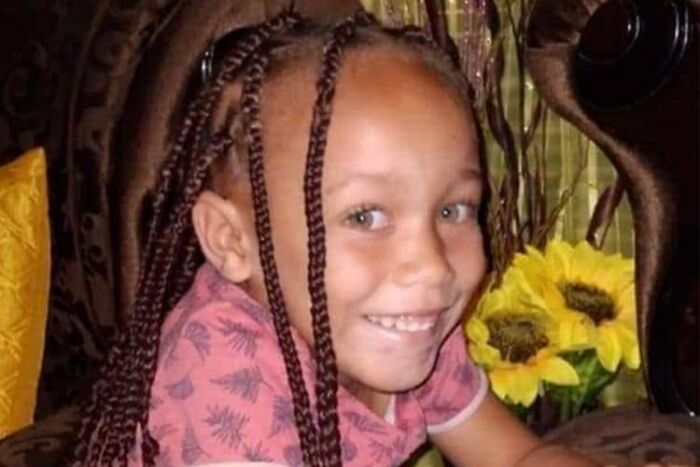 Young girl with braided hair smiling in a pink shirt, highlighting a mother jailed for life after selling daughter case.