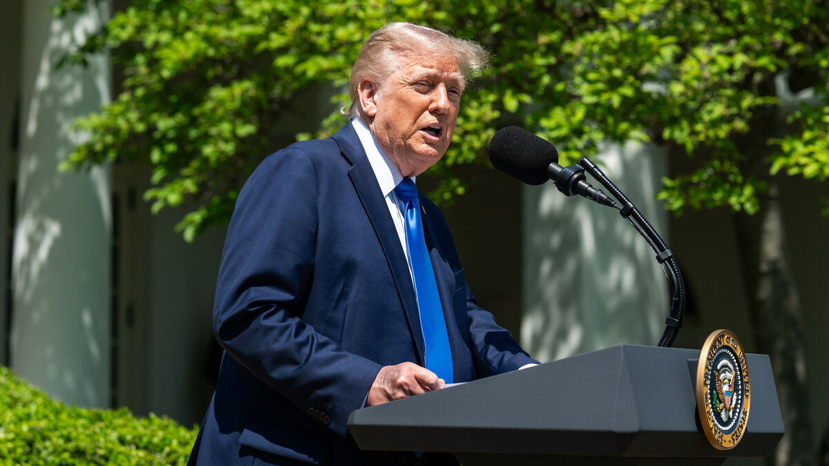 Donald Trump speaking at a podium outdoors, related to vaccine-friendly nominee and wellness influencer news.