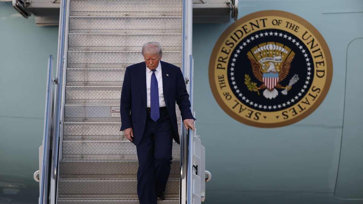 Donald Trump descending Air Force One stairs next to the presidential seal, linked to $400m flying palace from Qatar royals.