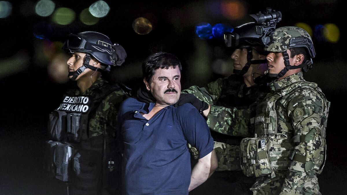 Mexican cartel family members escorted by military personnel at night, highlighting security concerns at U.S. border.