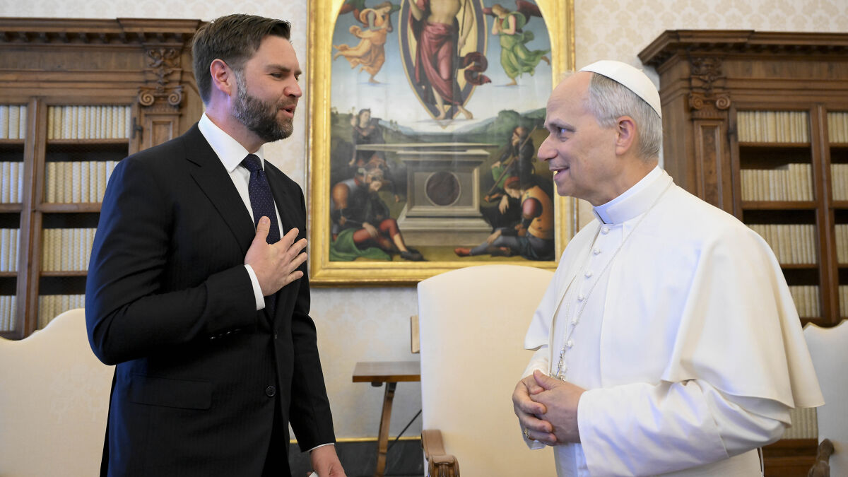 JD Vance in a suit speaking with Pope Leo dressed in white robes in a formal room with religious paintings and bookshelves.