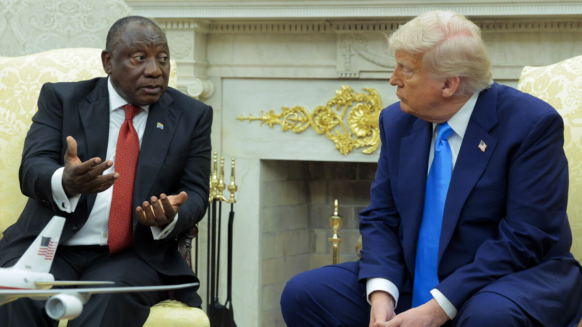 South African President and Trump seated in formal meeting room discussing issues related to white genocide narrative.