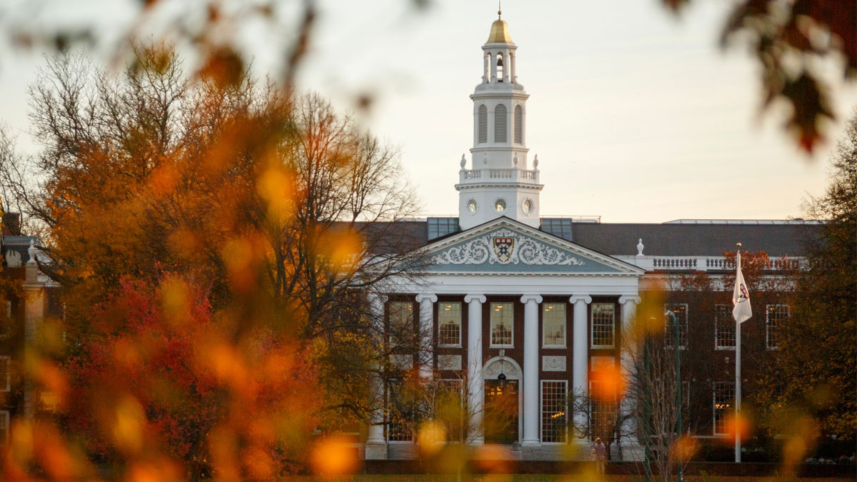Harvard University building in autumn with fall foliage, related to Trump ban on international student enrollment.