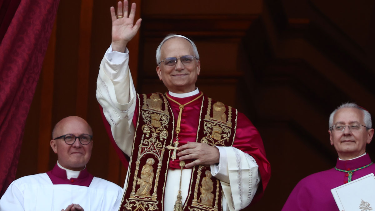 Pope Robert Prevost waving in traditional robes during public appearance as JD Vance responds to election news.