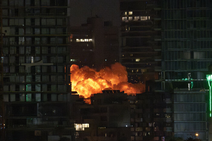 Explosion during U.S. Iran strikes at night amid urban buildings, raising doubts on the success of the military operation.