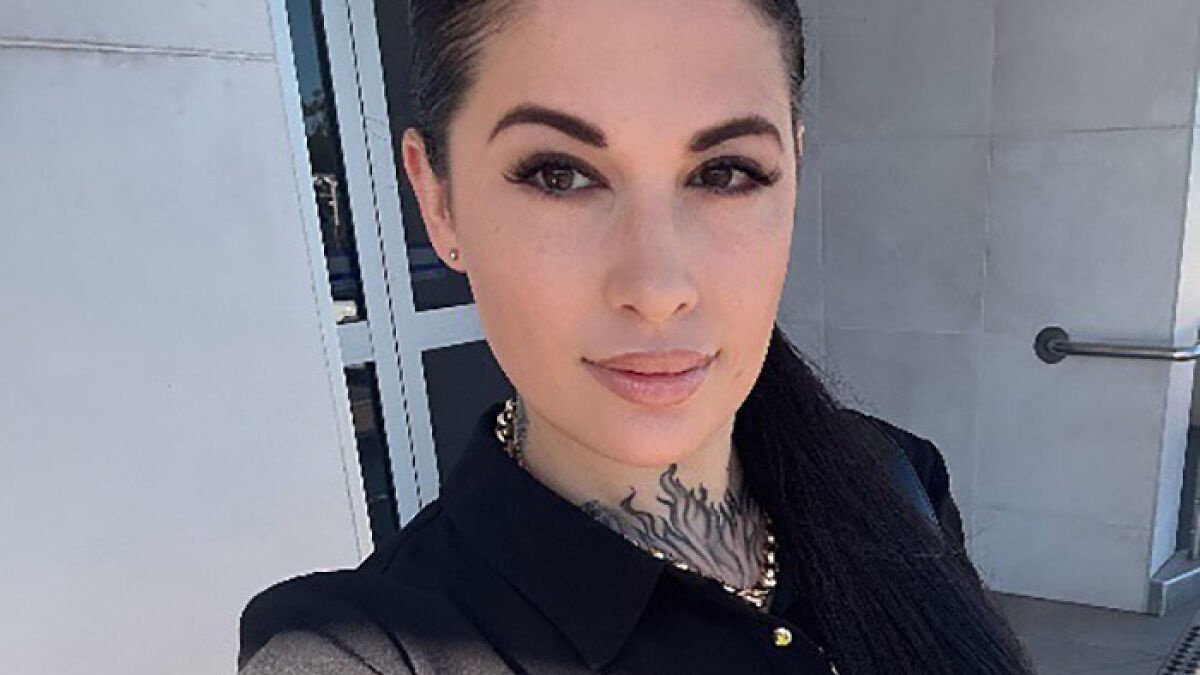 Woman with dark hair and tattoo on neck, outside building, related to Aussie mom accused of murdering daughter case