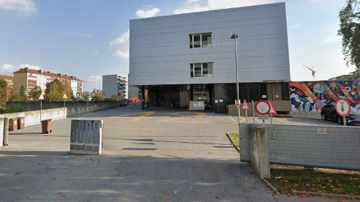 Police responding outside modern school building in Austria during reported shooting incident with casualties.