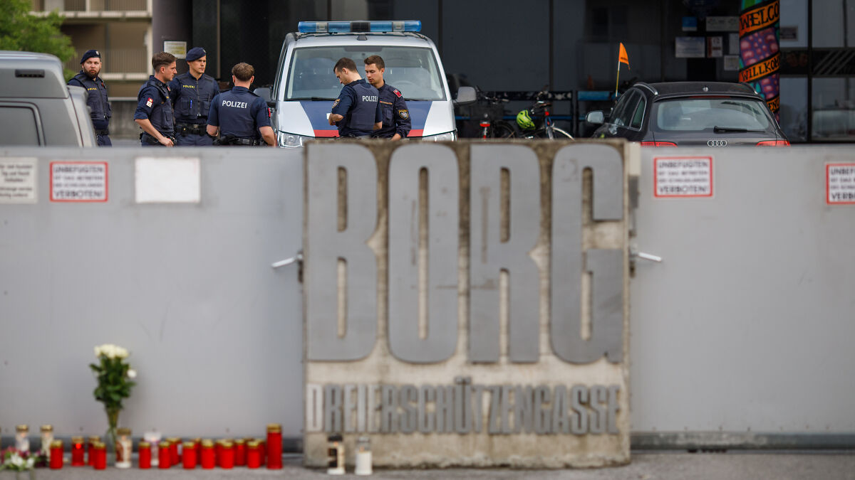 Police officers gather near a barricade outside a building in Austria after a shooteru2019s chilling video plan was revealed.