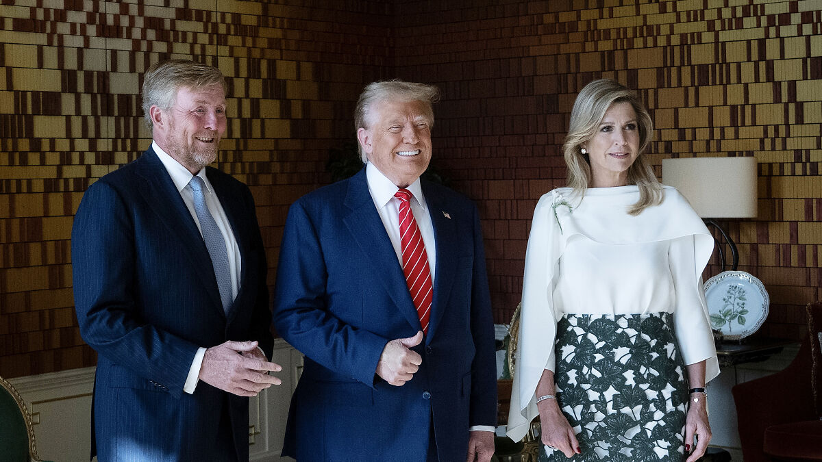 Donald Trump smiling with Dutch Queen and King, capturing facial expressions during a formal event indoors.