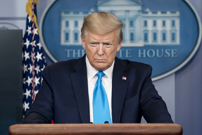 Former president speaking at White House podium with Agriculture Secretary suggesting Medicaid recipients replace farmworkers