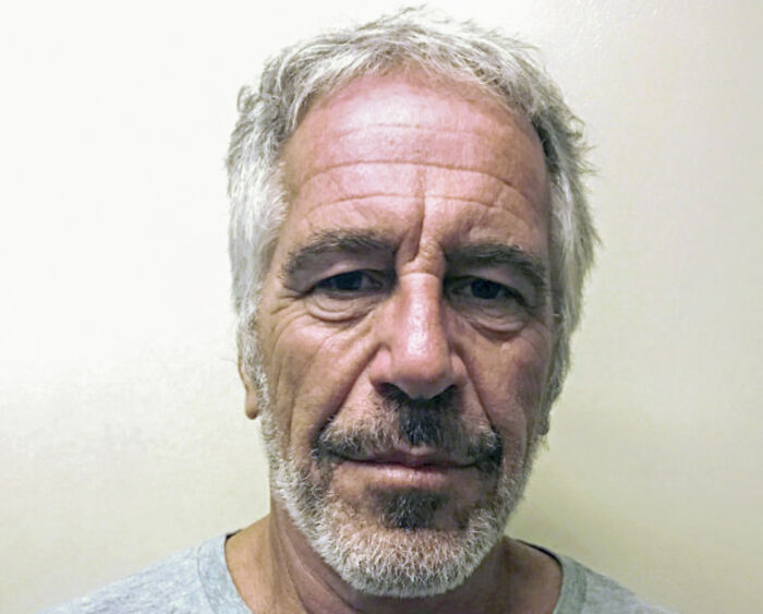 Mugshot of Jeffrey Epstein with gray hair and beard, related to DOJ and FBI statements on client list and death.