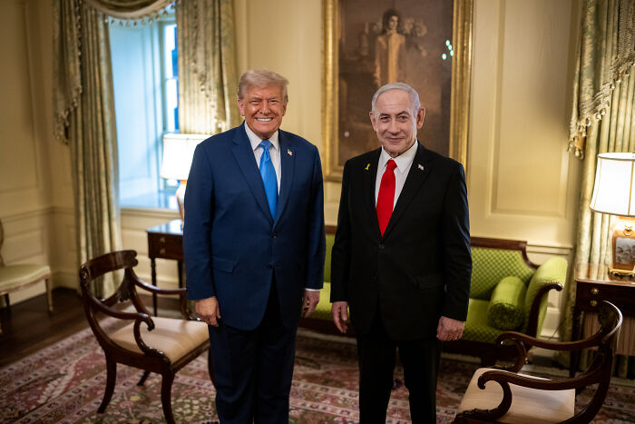 Donald Trump and Benjamin Netanyahu standing together in a formal room, relating to Nobel Peace Prize nomination.