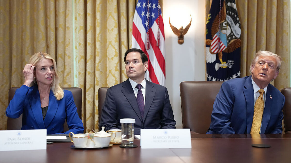Donald Trump and officials seated at a meeting table reacting amid MAGA meltdown over new Epstein findings.