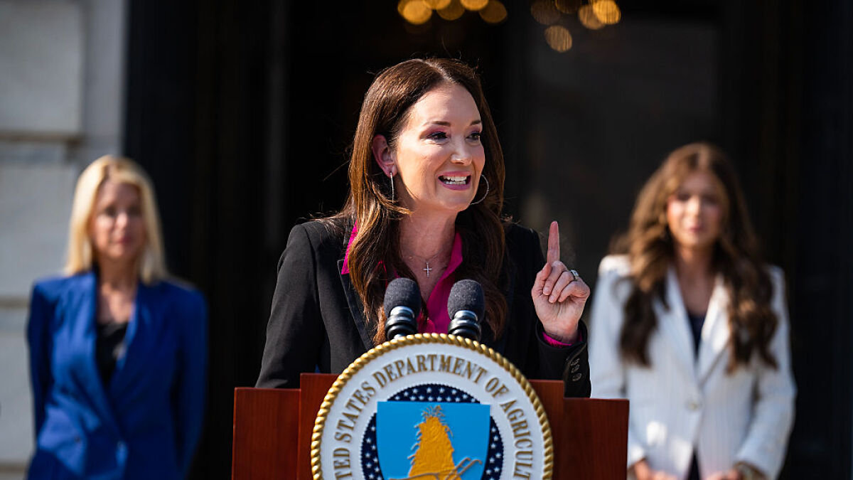 Agriculture Secretary speaking at a podium with US Department of Agriculture seal on replacing undocumented farmworkers.