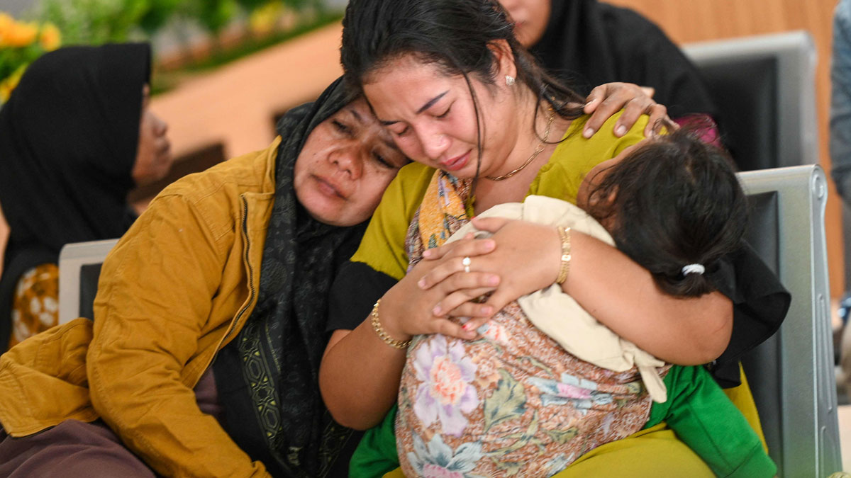 Relatives of missing passengers embrace each other, mourning after ferry carrying 65 sinks near Indonesiau2019s Bali coastline.