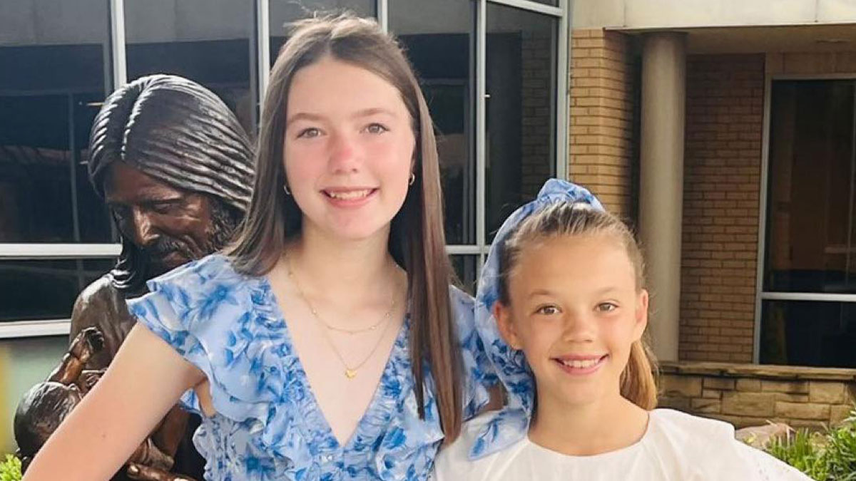 Two sisters smiling outdoors after Texas floods, highlighting sisters lost in Texas floods found with hands locked together.
